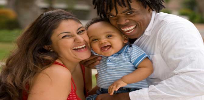 Interracial family holding baby in middle